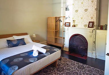Master bedroom with queen bed and fireplace.