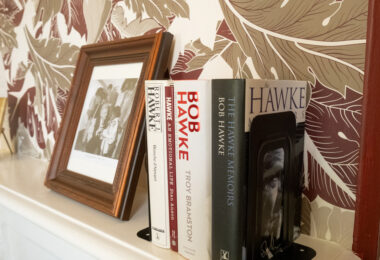 Mantle piece with several book lined up.