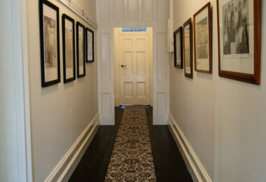 Hallway entrance with photos lining the walls.
