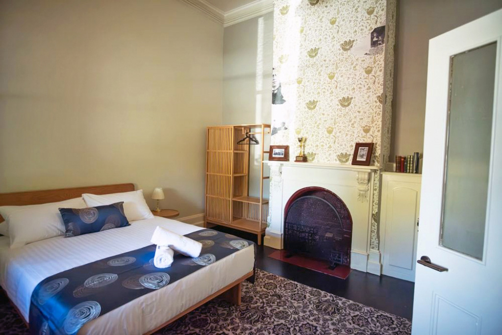 Master bedroom with queen bed and fireplace.
