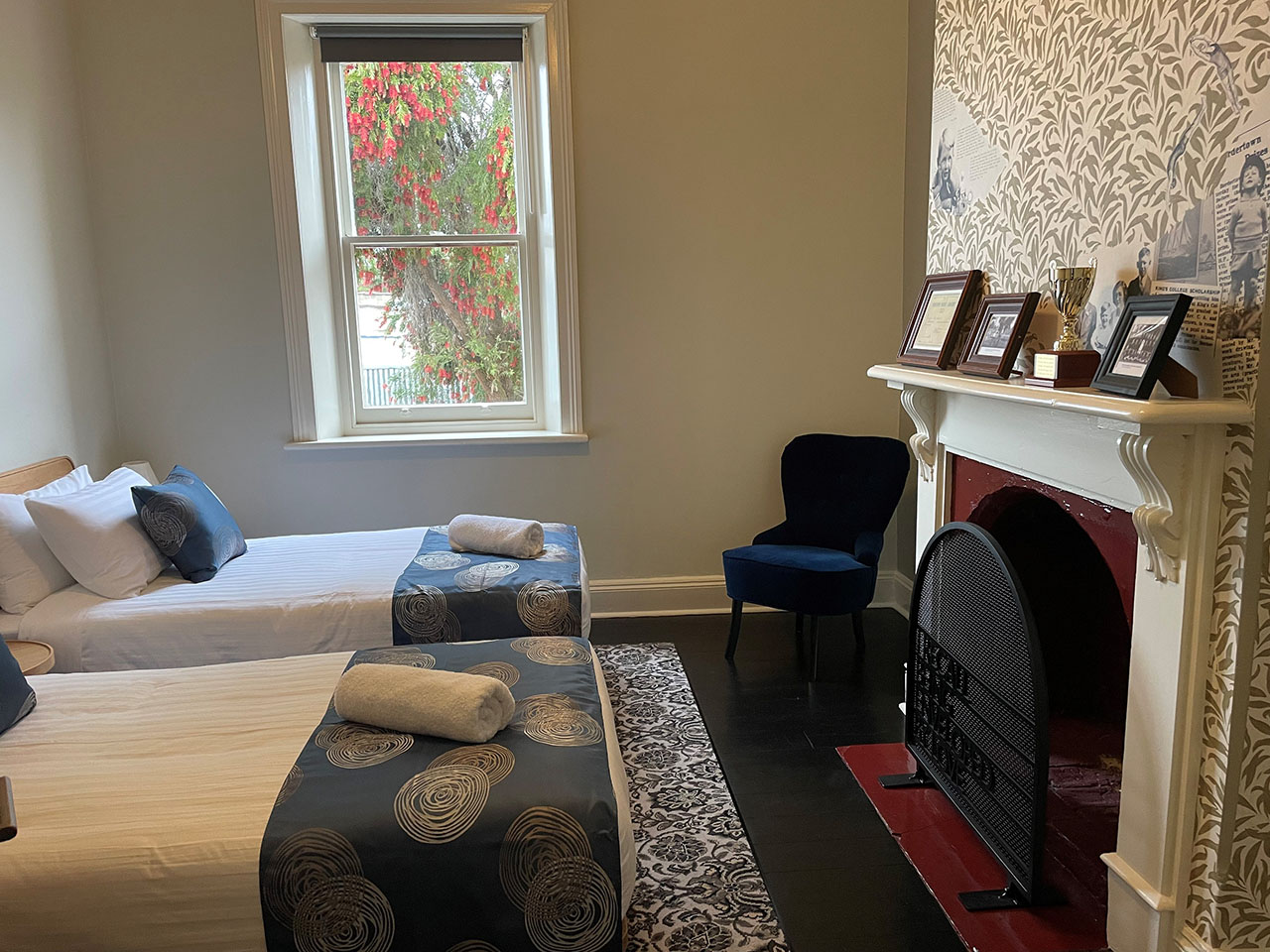 Second bedroom with two single beds and fireplace.